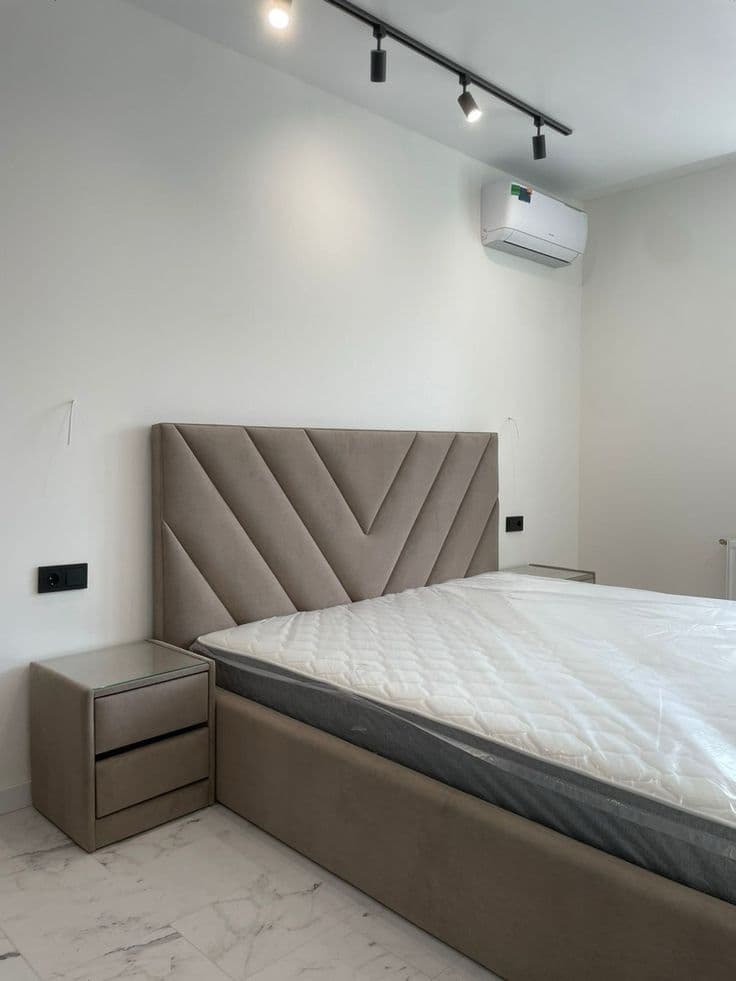 Upholstered bed panel fitted in a bedroom — example 3
